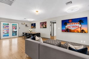 A modern living room with a dining area, a sofa set, and a Las Vegas sign. - Upgraded King Beds Pool BBQ Near Strip (Las Vegas)