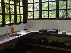 Kitchen features a sink and cooking appliances.
