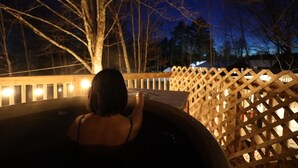 A person in a hot tub with a wooden fence and trees in the background. - Blue House in Smallwood NY, Year round, 2-bed in Catskill Mts (Monticello)