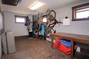 A room with a bicycle rack, a table, and a window.