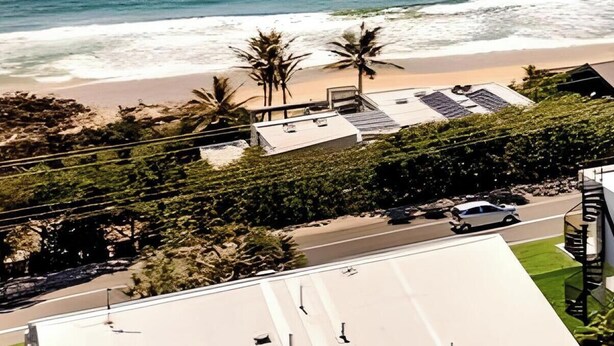 An aerial view of a beachfront property with a small block of 4 units, including a beach and ocean view. - THE GRASSY KNOLL Panoramic Beach Apartment  - Sunrise Beach (Sunrise Beach)