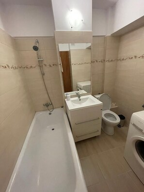 Combined shower/bathtub, hair dryer, towels, soap