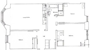 Pianta dei pavimenti con un soggiorno/cucina, due camere da letto, un bagno e un disimpegno.