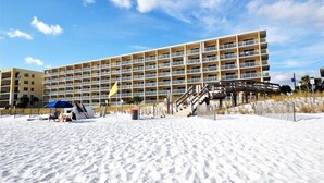 A multi-story hotel with balconies, located on a sandy beach. - Pelican Isle 217 Gulf front with Balcony sleeps 6 (Fort Walton Beach)