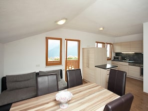 Relax in a spacious living area with a dining table, comfortable sofa, and kitchenette.