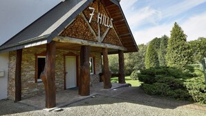 A building with a sign reading "7 Hills" and a stone facade. - Luxurious Holiday Home in Stoumont with Pool & Bar (Stoumont)