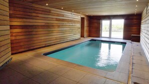 A rectangular indoor pool with wooden panel walls and a tiled floor. - Comfortable chalet with indoor pool, hammam and sauna near Stoumont (Stoumont)