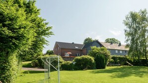 A residential property with a well-maintained lawn, a soccer goal, and a house with a sloped roof. - Spacious Holiday Home in Chodes with Sauna (Malmédy-Boussire)