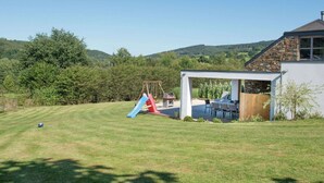A house with a stone exterior and a covered patio area. - Holiday Home in Stoumont with Private Pool (Stoumont)