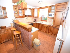 Fridge, stovetop, dishwasher, coffee/tea maker