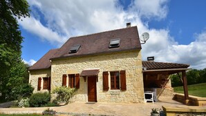 A stone house with a tiled roof, wooden shutters, and a satellite dish. - Spacious holiday home with private pool (Uzech)