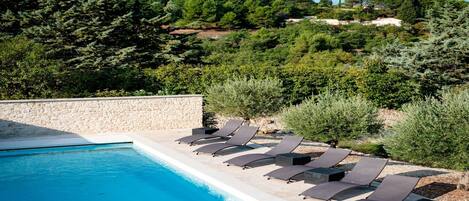 A heated pool, pool loungers