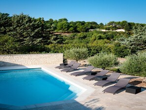 A heated pool, pool loungers