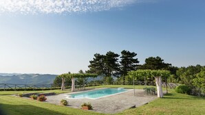 A swimming pool with a view of the mountains, surrounded by a fence and trees. - Villa with private swimming pool (Tredozio)