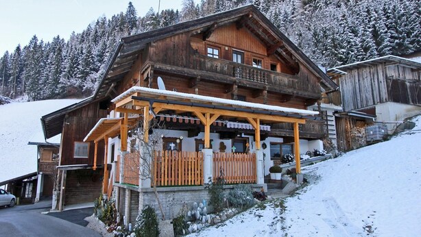 A wooden chalet with a balcony, surrounded by snow-covered trees. - Apartment in Kaltenbach near Ski Lift (Kaltenbach)