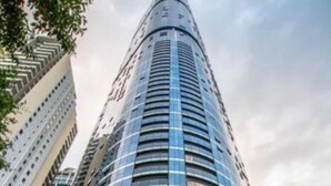 A modern skyscraper with a curved entrance and the number 222. - 2BR Luxury Skytower CBD Pool Gym Netflix (Brisbane)