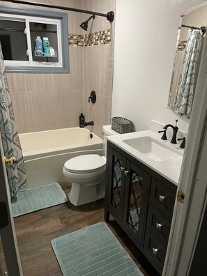 Bathtub, towels, soap, shampoo
