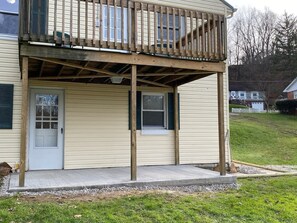 A two-story house with a covered porch and a front door.