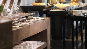 A buffet setup with multiple serving stations, including a variety of food items and condiments.