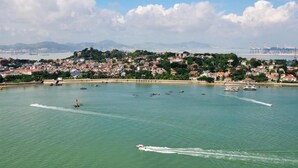 A coastal cityscape with a marina, boats, and residential buildings. - Fuman Renjia Hotel Xiamen Zhongshan Road (Xiamen)