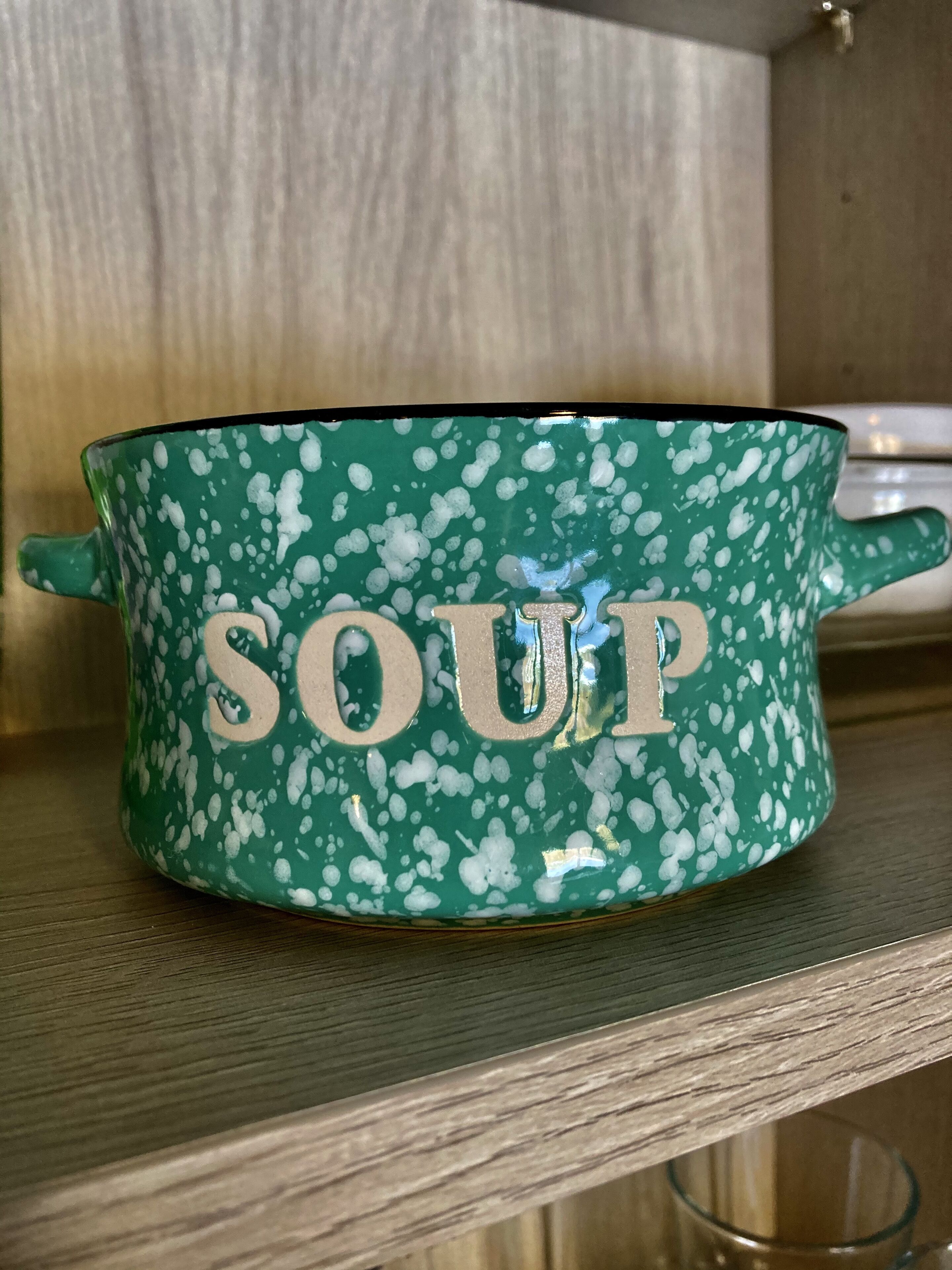 A green pot with white splatter design and the word "SOUP" on it.