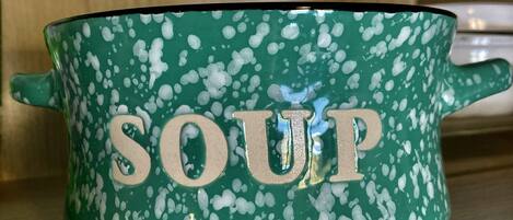 A green pot with white splatter design and the word "SOUP" on it.
