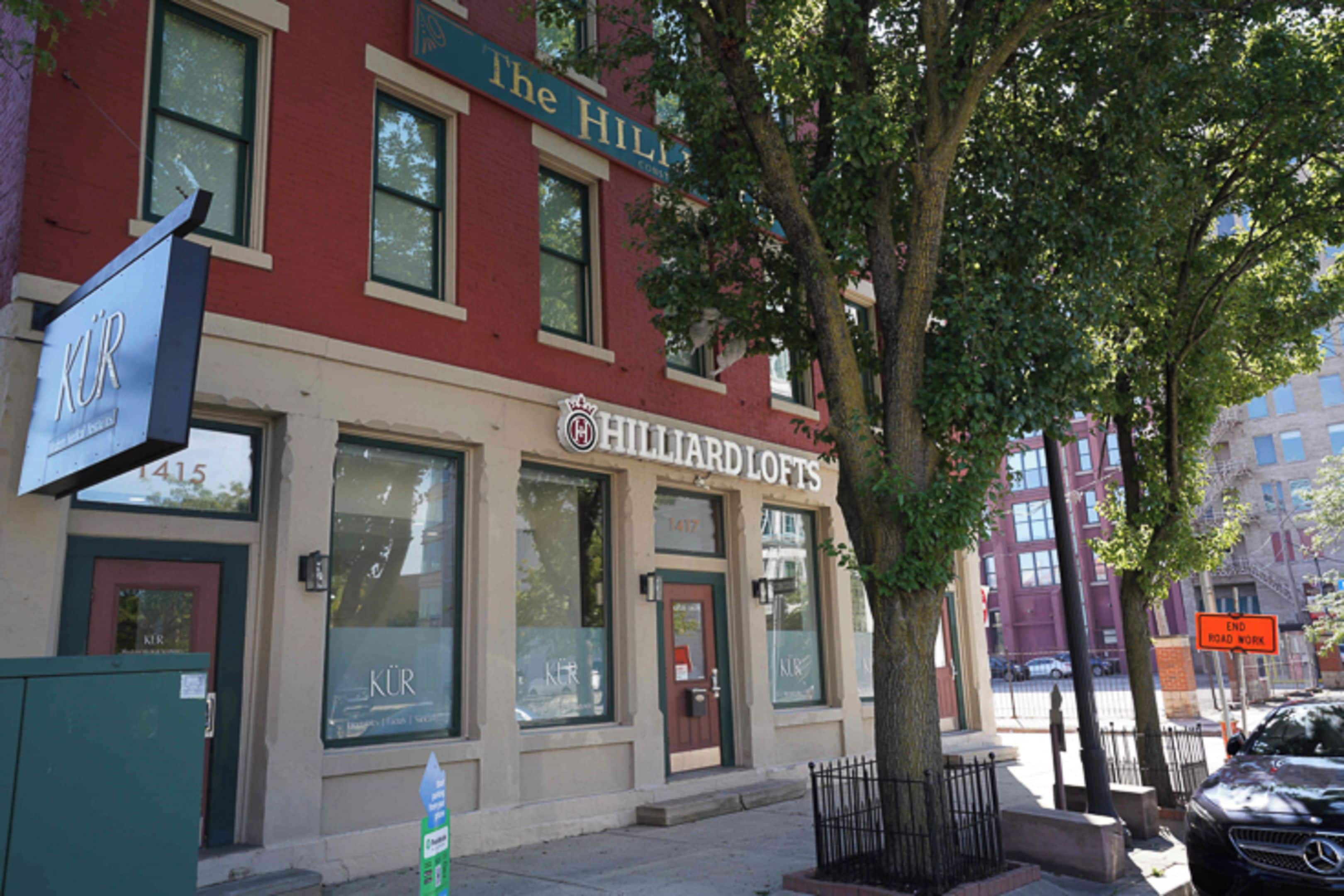 A building with a sign for 'The Hillard Lofts' and a visible entrance.