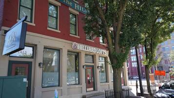 A building with a sign for 'The Hillard Lofts' and a visible entrance.