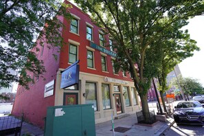 A red brick building with a storefront named 'HILLIARD LOFTS' and a sign for 'KUR' above it. - Downtown Historic Warehouse District Lofts 309 (Cleveland)