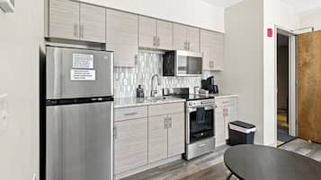 A modern kitchen with stainless steel appliances, a microwave, and a built-in oven.