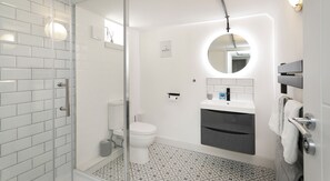 Separate bathtub and shower, towels