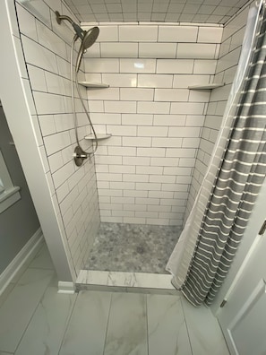 Shower, hair dryer, towels, toilet paper