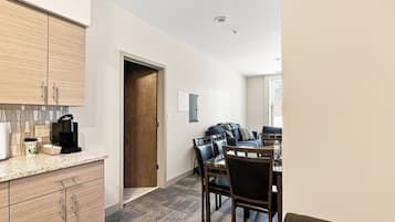 A modern kitchen with wooden cabinets and a coffee maker.