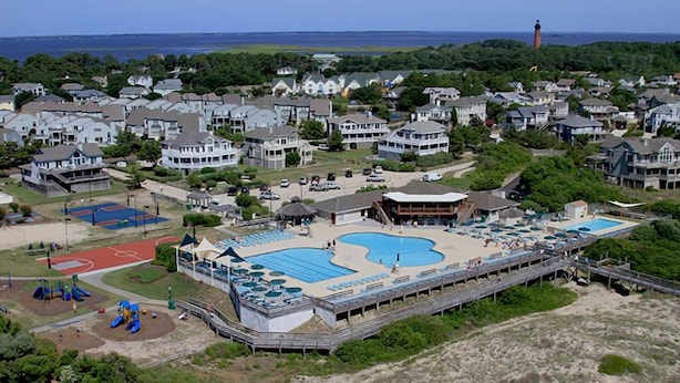 A coastal resort with a large swimming pool, tennis courts, and a lighthouse in the background. - Corolla Light Resort! Dogs! Heated Pool! Hot tub! Walk to restaurants! C1131 (Corolla)
