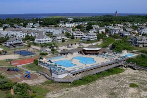 A coastal resort with a large swimming pool, tennis courts, and a lighthouse in the background. - Corolla Light Resort! Dogs! Heated Pool! Hot tub! Walk to restaurants! C1131 (Corolla)