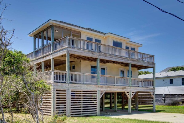 A two-story house with a balcony on the upper floor.