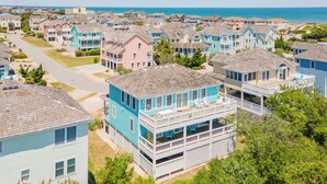 A coastal residential area with houses featuring balconies and a view of the ocean. - Modern, Community Pool, Quick walk to beach! Hot tub! NH4912 (Nags Head)