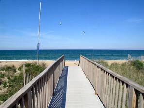 A wooden boardwalk leading to a beach with a clear view of the ocean. - Modern, Community Pool, Quick walk to beach! Hot tub! NH4912 (Nags Head)