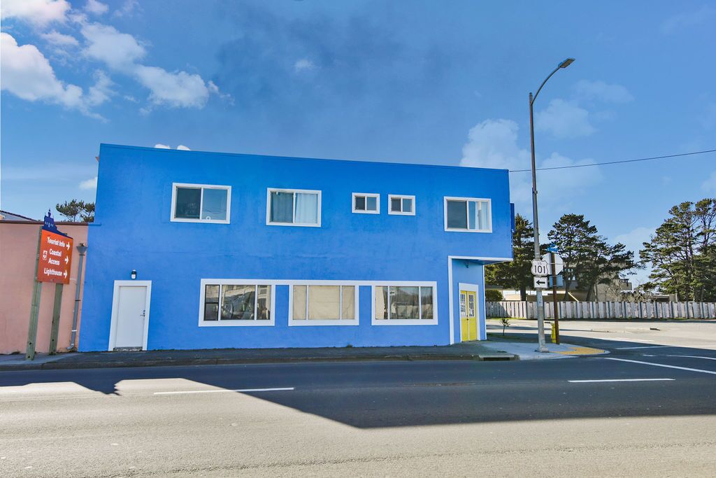A two-story building with a blue exterior and white windows.