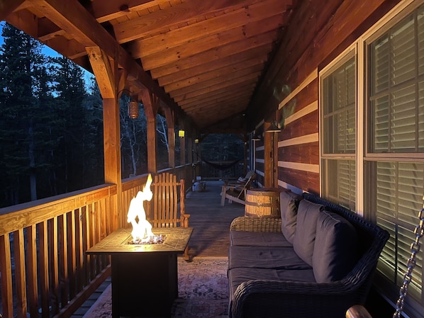 Relax on the covered porch with a fire pit and comfortable seating.