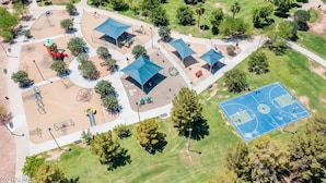 An aerial view of a park with multiple shaded areas, a basketball court, and various playground equipment. - The Auburn at Tempe | Heated Pool + Park Adjacent (Tempe)