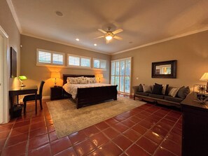 A bedroom with a bed, a desk, a chair, a sofa, and a ceiling fan. - Crescent House - Tranquil Downtown Home (Lodi)