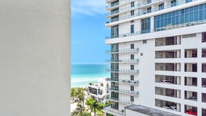 A multi-story hotel with balconies overlooking a beach and ocean. - Hollywood Beach Glam (Hollywood)