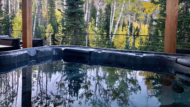 A hot tub with a clear view of a forested area in the background. - Ski-Access and View Chair 5 Runs From Cabin in Brian Head, UT (Brian Head)