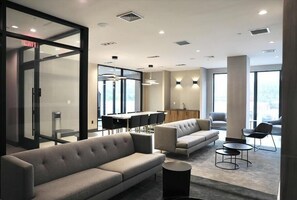Contemporary office space with seating, dining, and kitchen areas.