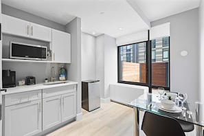 Microwave, coffee/tea maker, toaster, dining tables - Mott Haven King Suite | Gym | Kitchenette | Free Wi-Fi (Bronx)