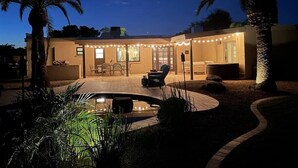 A house with a patio, outdoor seating, and a swimming pool. - Kierland oasis, pool heater, spa, putting green (Scottsdale)