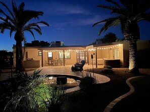 A house with a patio, outdoor seating, and a swimming pool. - Kierland oasis, pool heater, spa, putting green (Scottsdale)