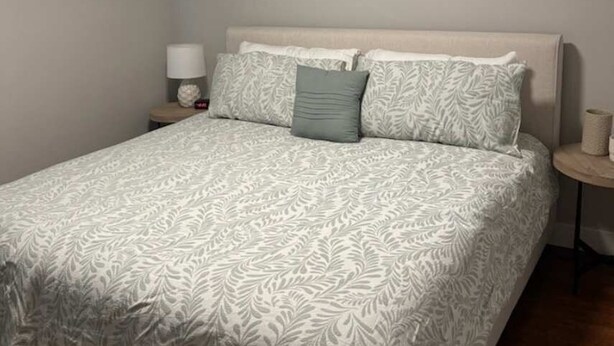 A bedroom with a bed, a nightstand, and a lamp. - Kierland oasis, pool heater, spa, putting green (Scottsdale)