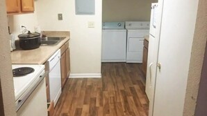 A compact kitchen with a stove, sink, and washing machine. - Get Away Sanctuary in Stone Mountain Mins from ATL (Stone Mountain)